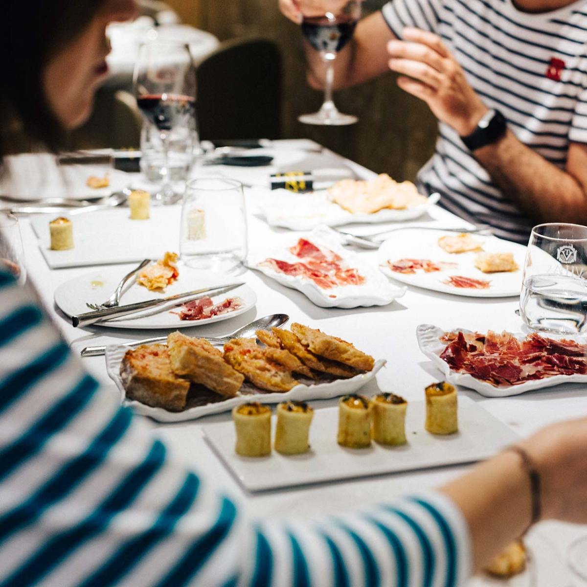 a person sitting at a table with a plate of food