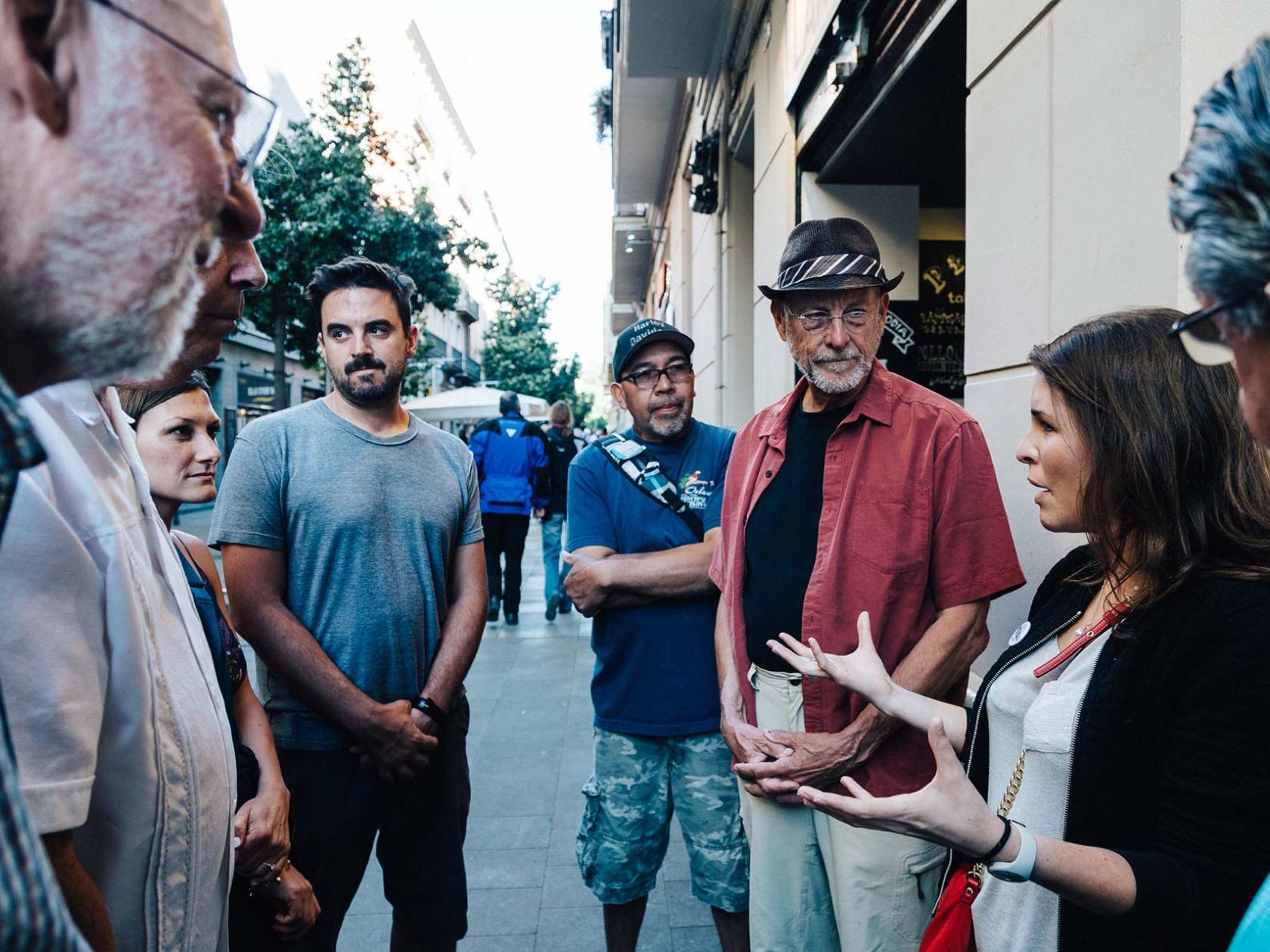 a group of people standing on a sidewalk