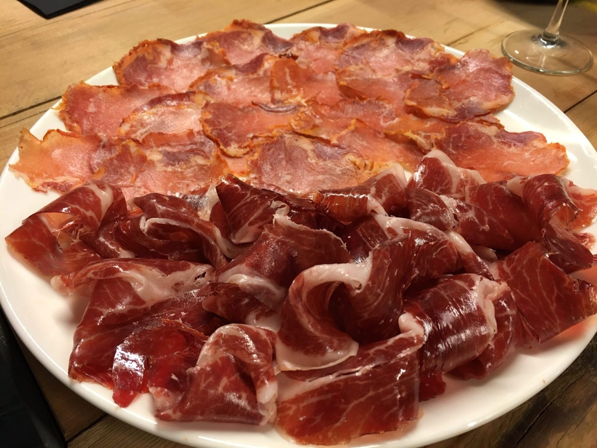 A plate full of delicious Spanis cured ham during the Food Lover Barcelona Tapas Crawl