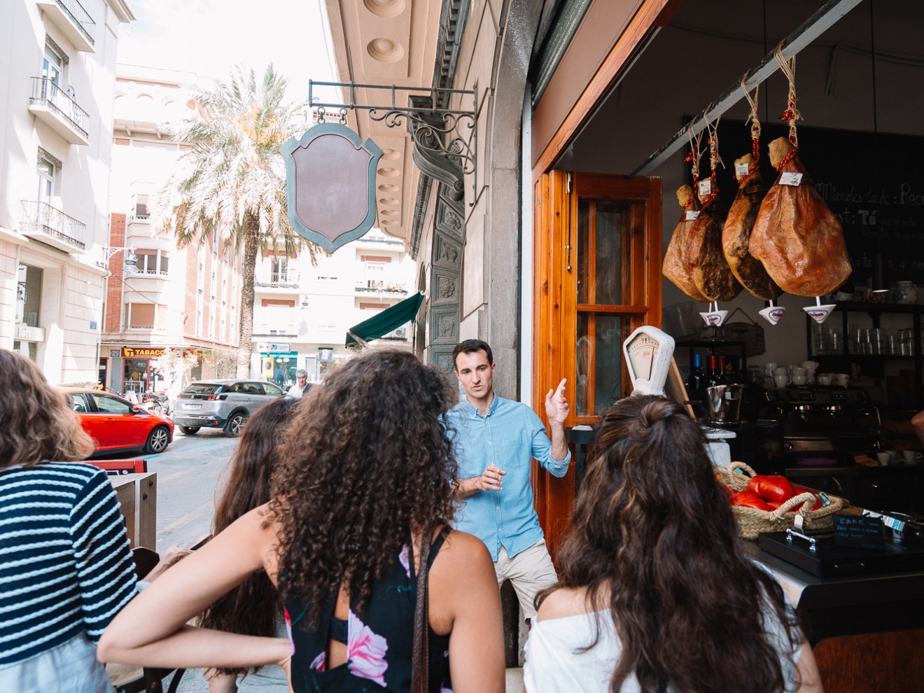 a group of people sitting at tables eating food