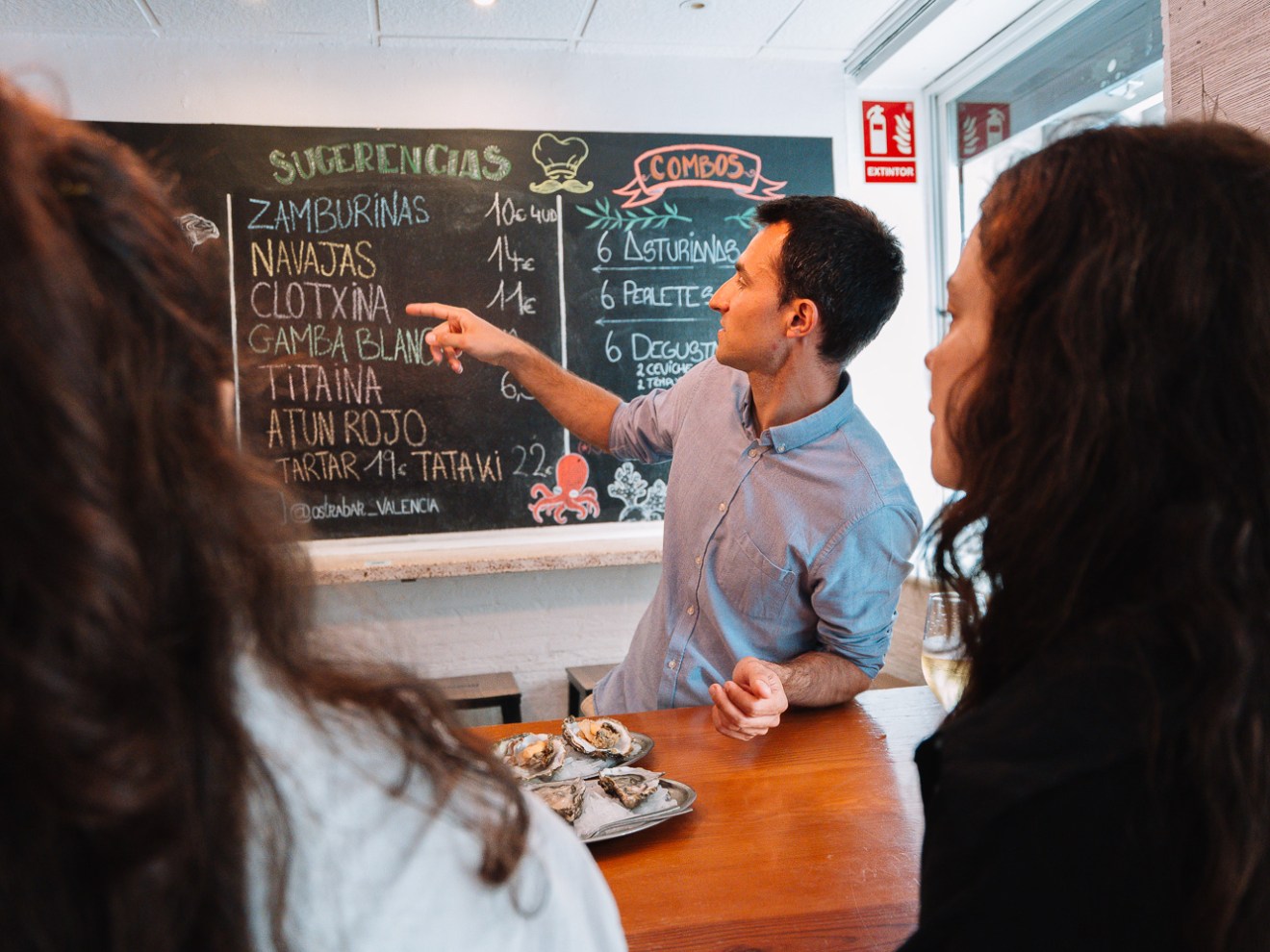 a man and a woman standing in front of a table