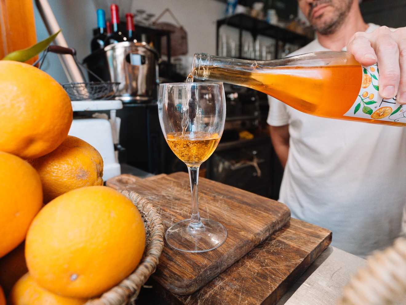a bowl of oranges on a table