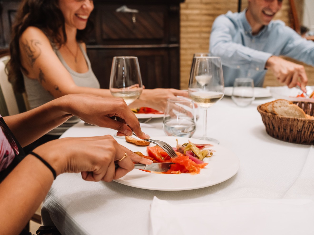 a woman sitting at a table with a plate of food