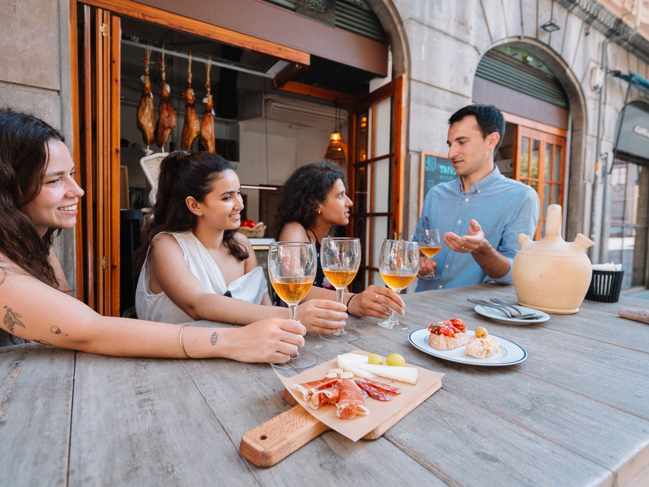a group of people sitting at a table eating food