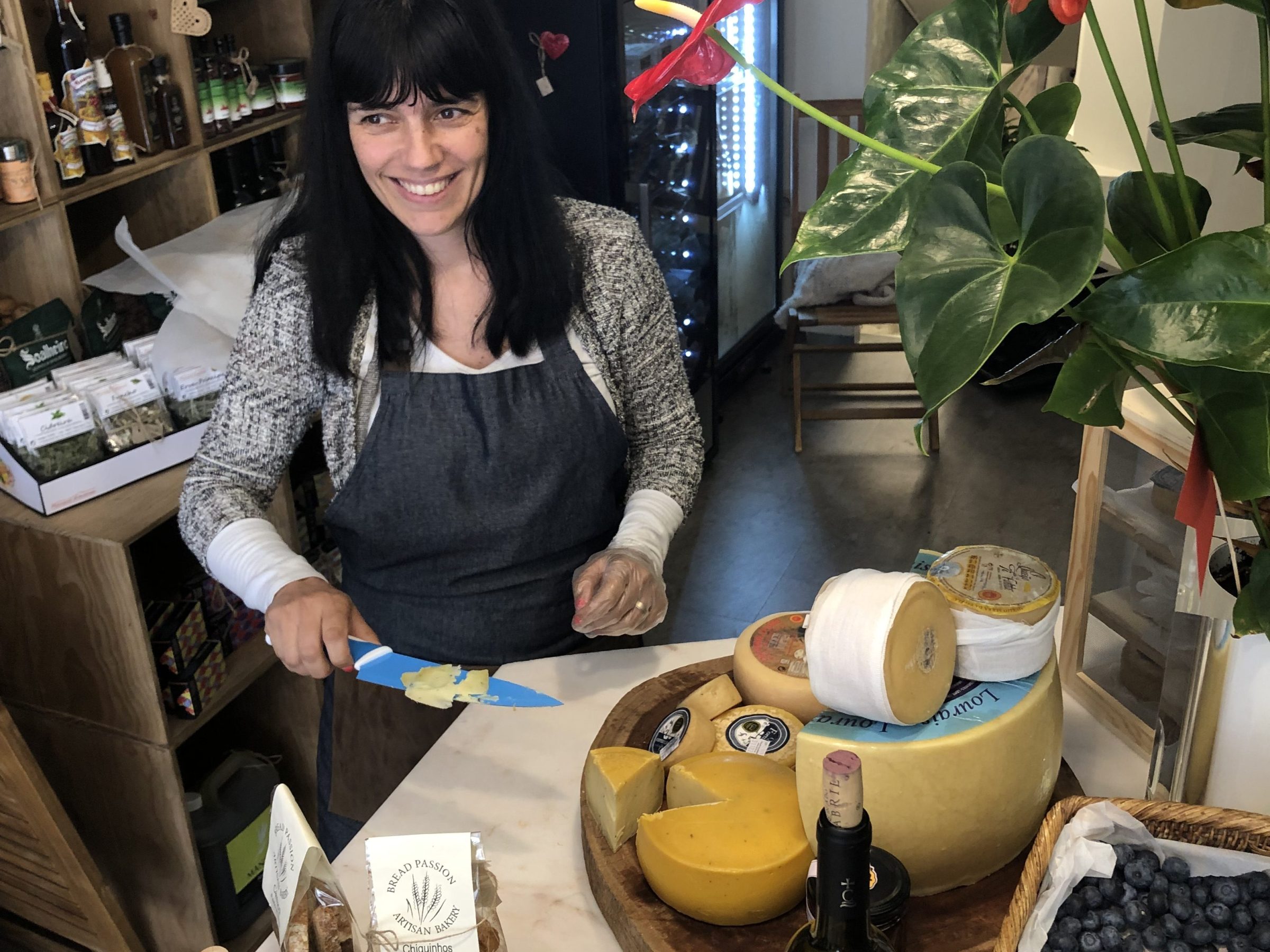 a woman sitting at a table with food