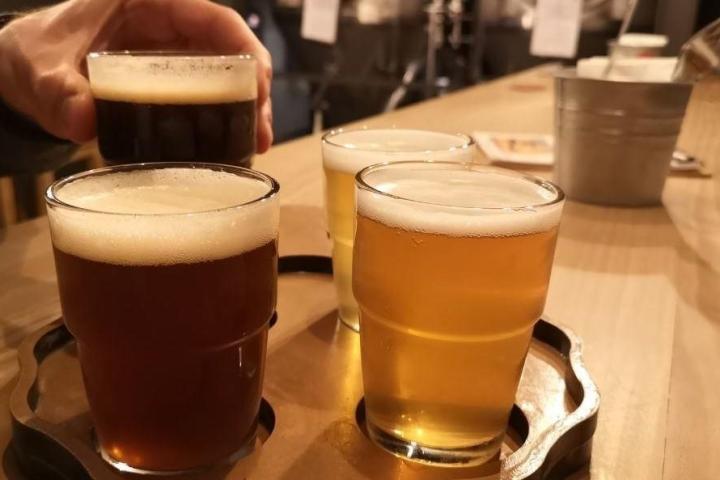 a cup of coffee and a glass of beer on a table