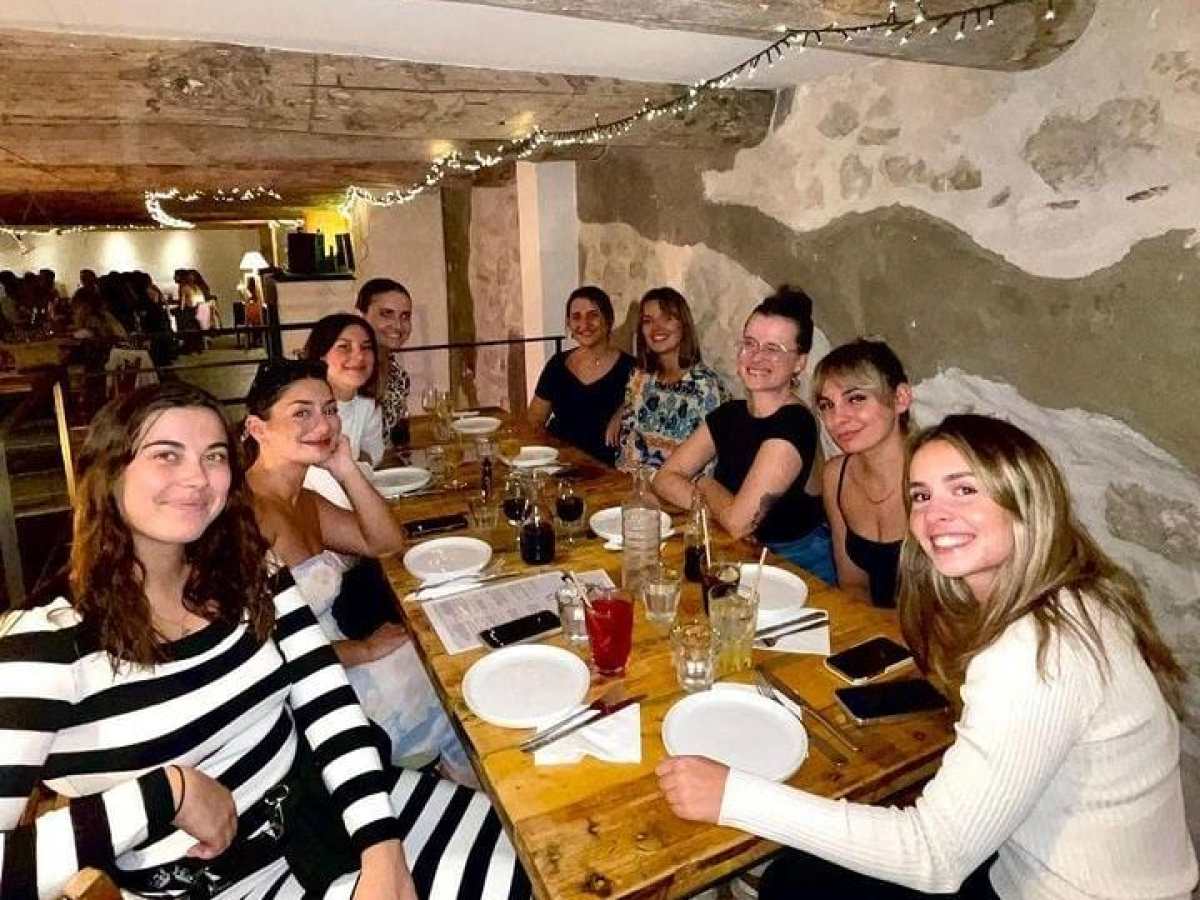 a group of people sitting at a table posing for the camera