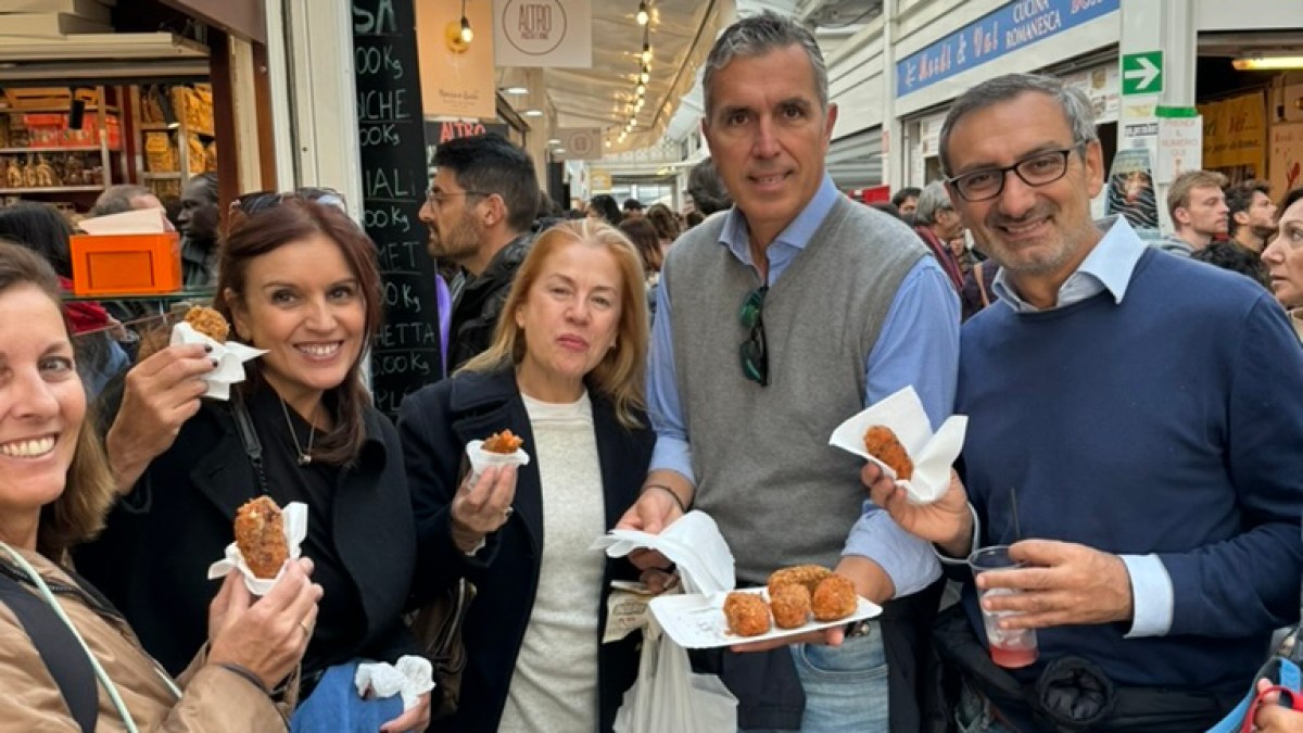 a group of people standing in front of a store