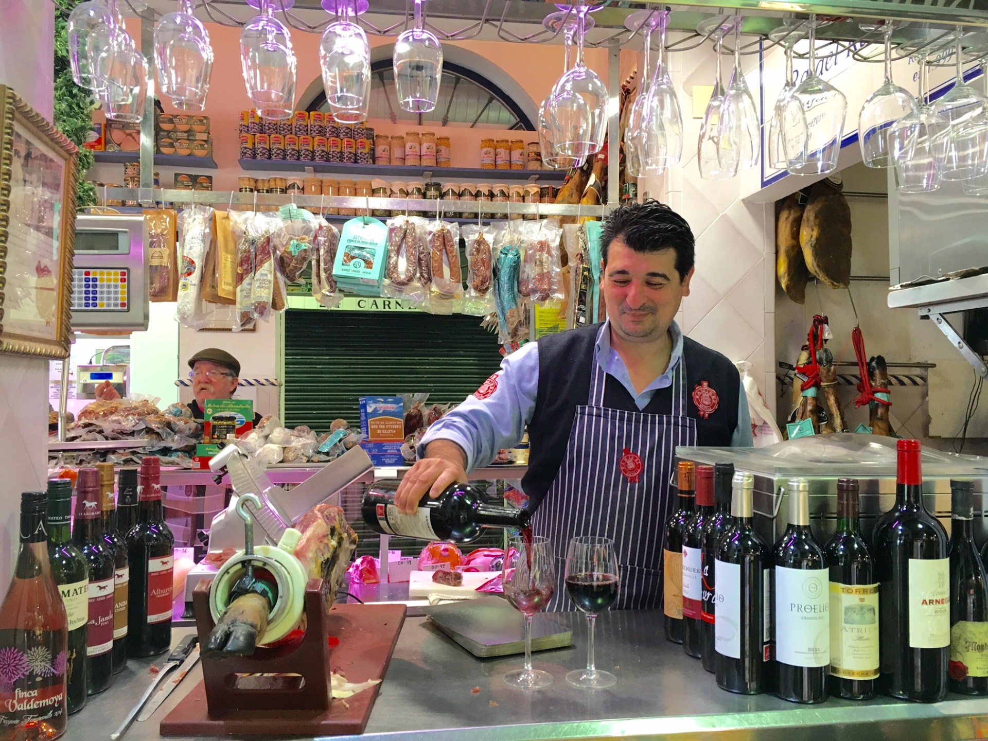 Radu Sirbu standing next to a bottle of wine