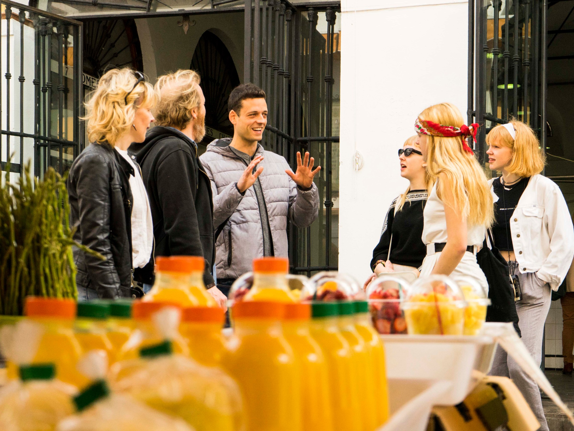 a group of people standing in front of a cake