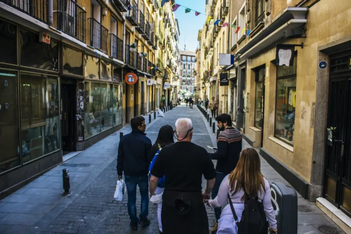 a group of people walking on a city street