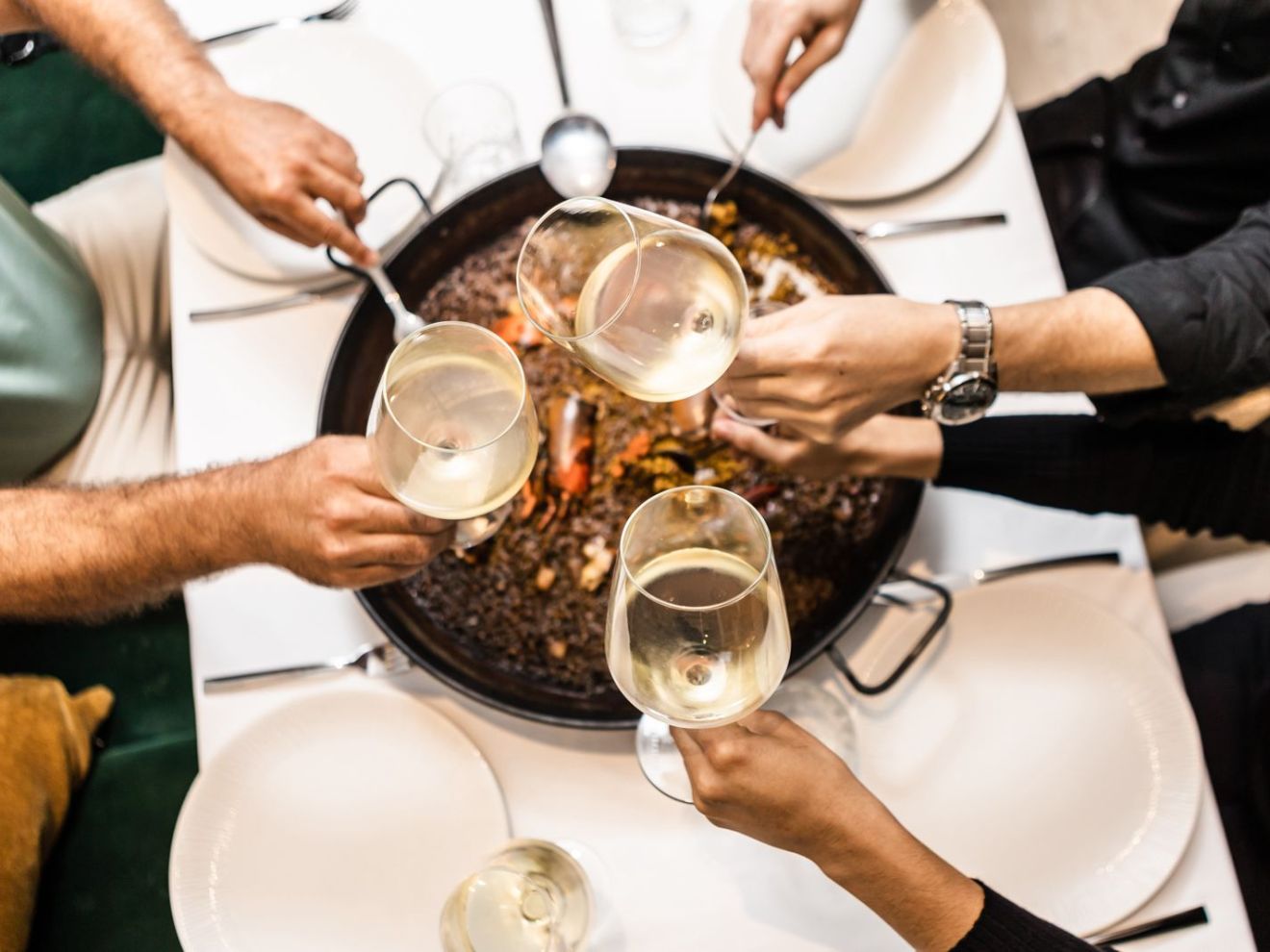 a person sitting at a table with a plate of food