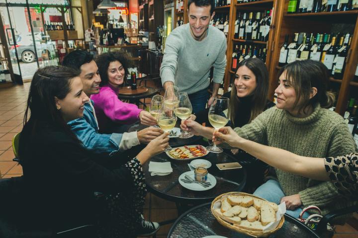 a group of people sitting at a table eating food