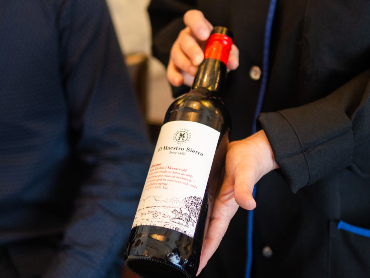 a person holding a bottle of wine