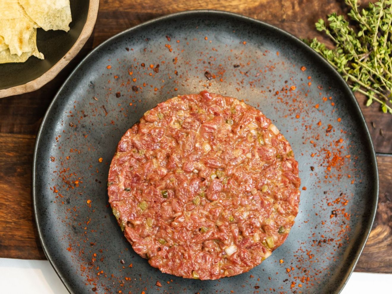 a pizza sitting on top of a pan on a table