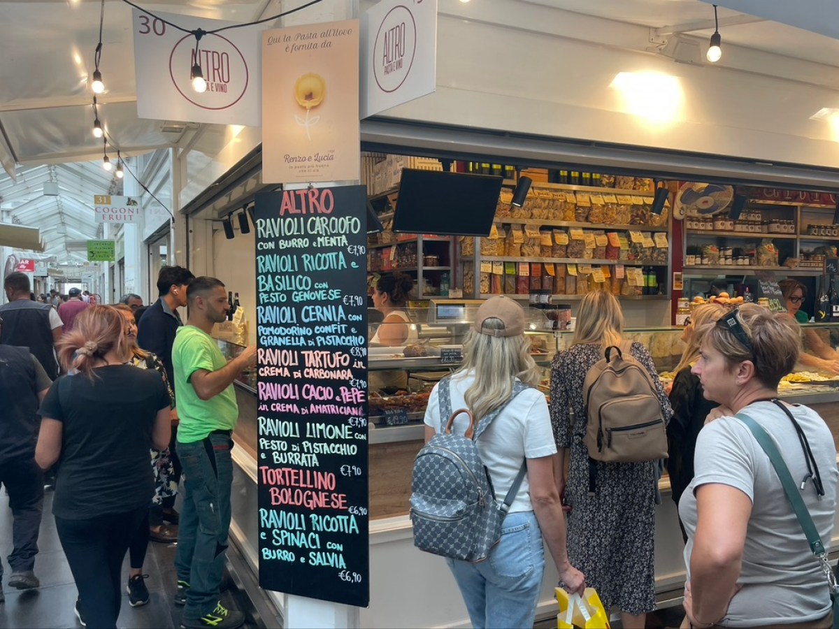 a group of people standing in front of a store