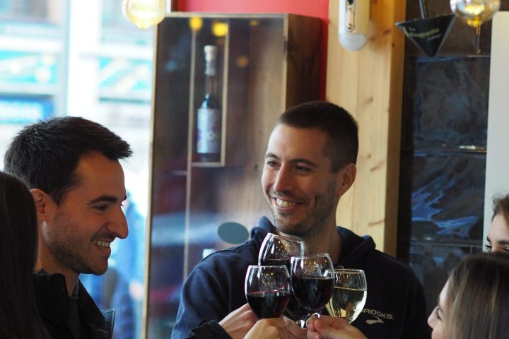 a man drinking a glass of wine
