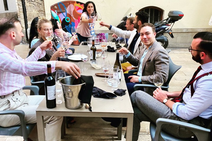 Filomena Moretti et al. sitting at a table