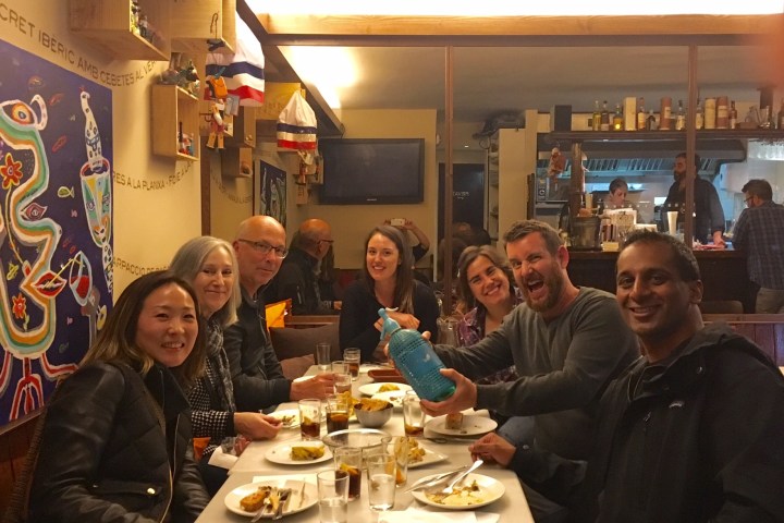 a group of people sitting at a table eating food