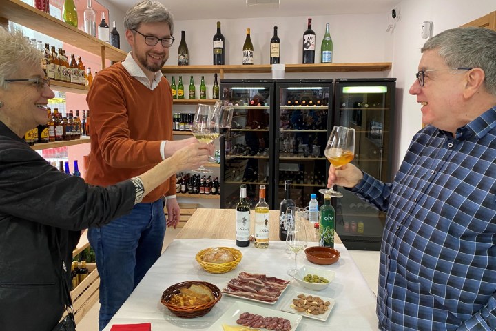 a person standing by a table with food