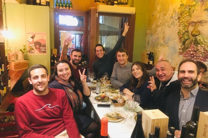 a group of people sitting at a table posing for the camera