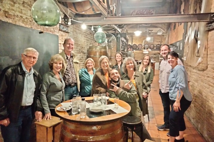 Laurel Thatcher Ulrich et al. standing around a table with wine glasses