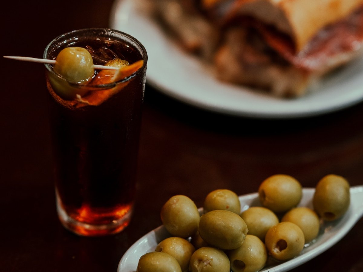 a plate of food and a glass of beer on a table