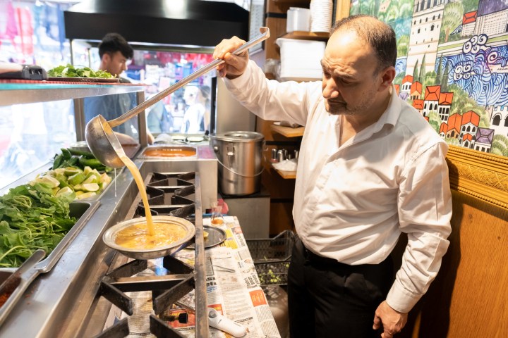 a man standing in a kitchen preparing food