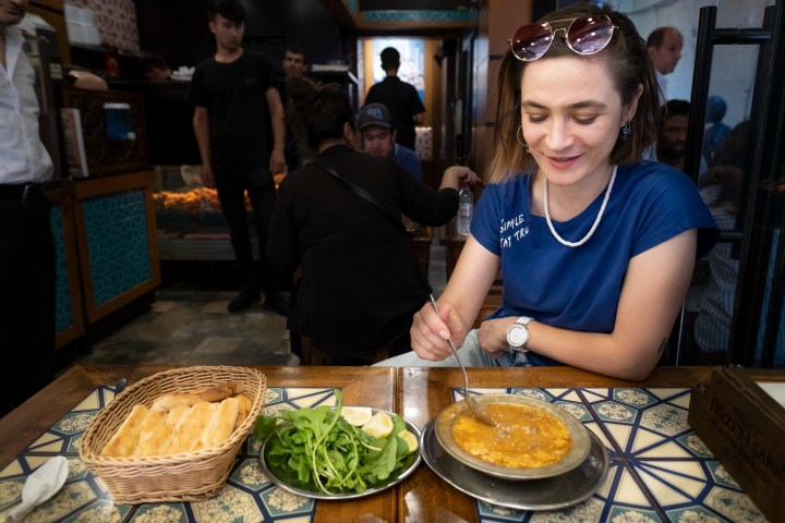 a woman sitting at a table with a plate of food
