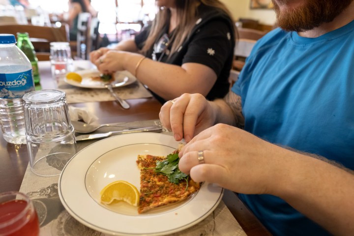 a woman sitting at a table with a plate of food
