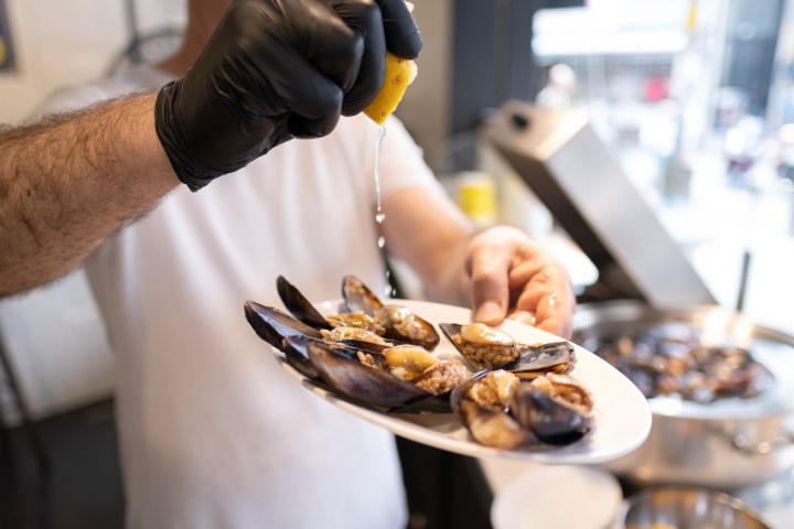 a person preparing food on a plate