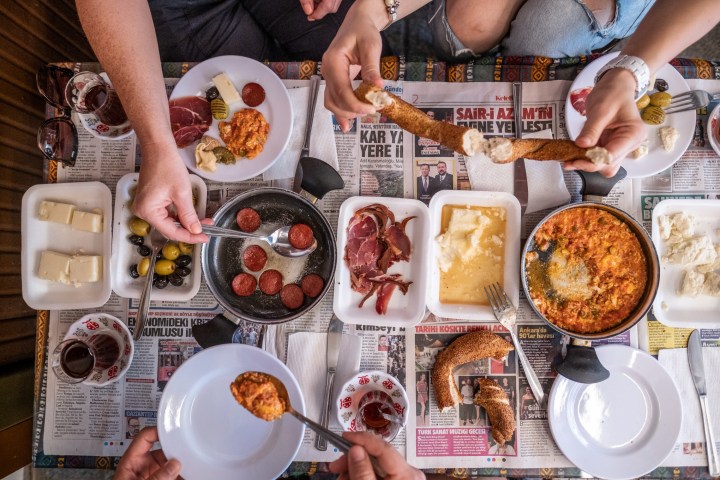 a group of people sitting at a table with a plate of food