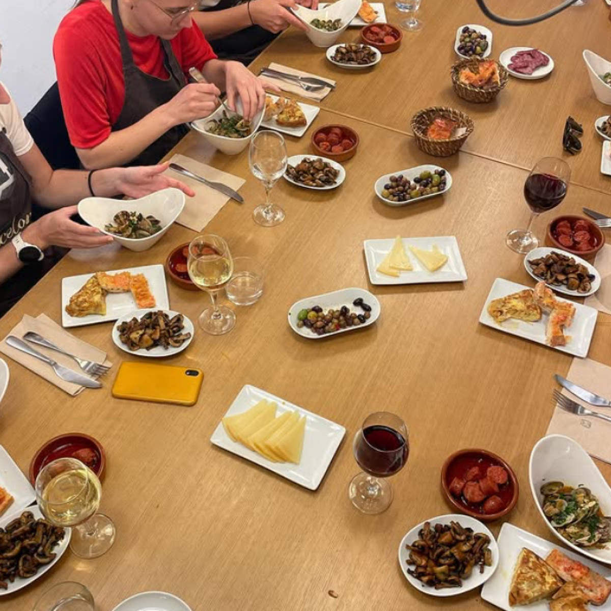 a group of people sitting at a table eating food
