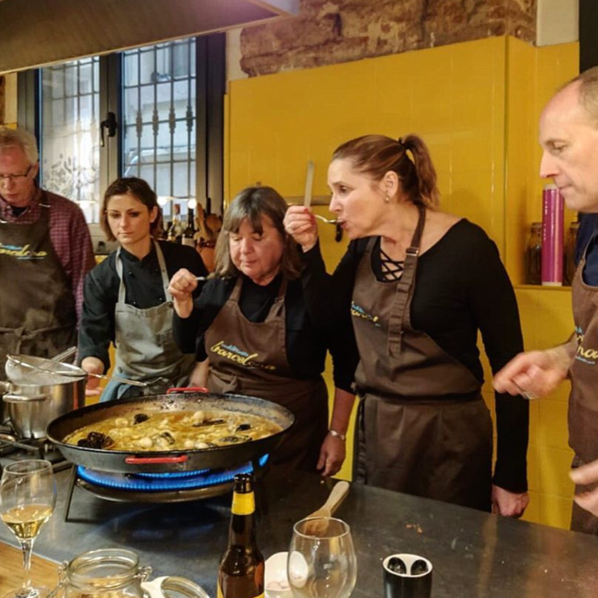 a group of people standing around a table