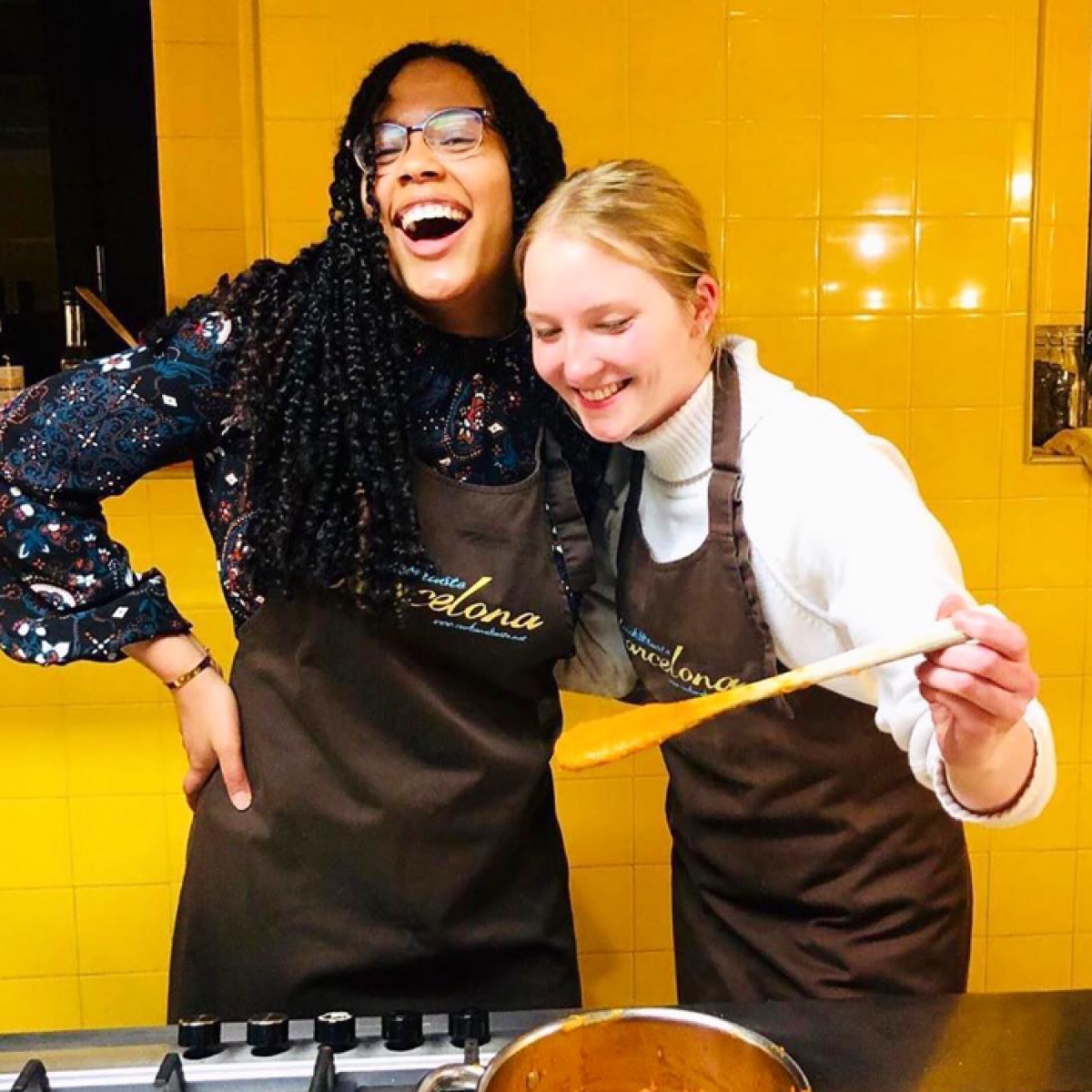 a person holding a pair of people posing for the camera