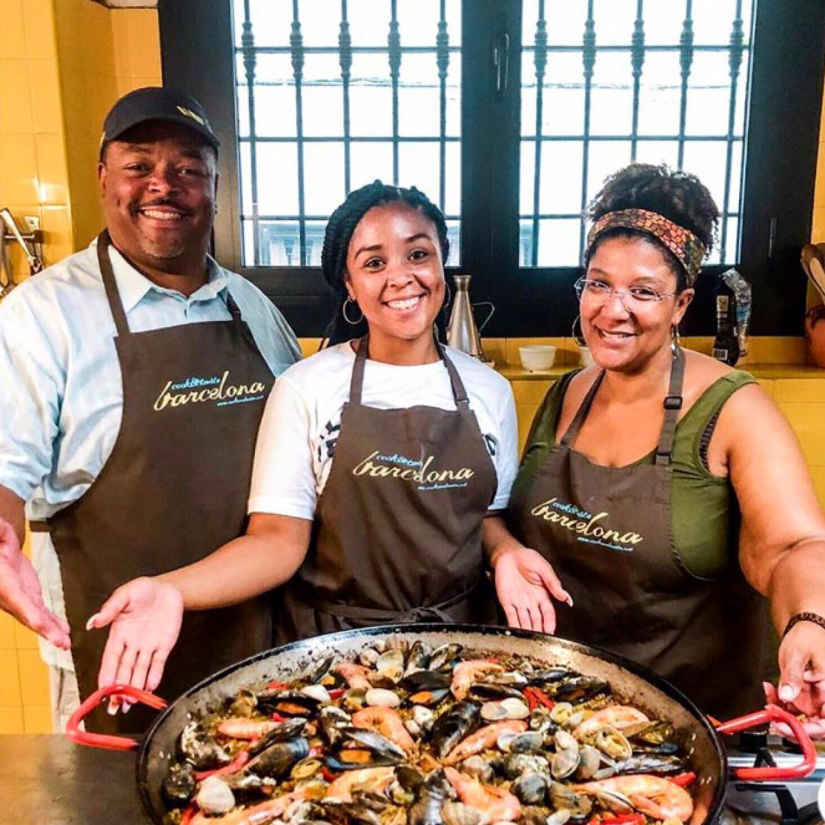 a group of people sitting at a table with pizza