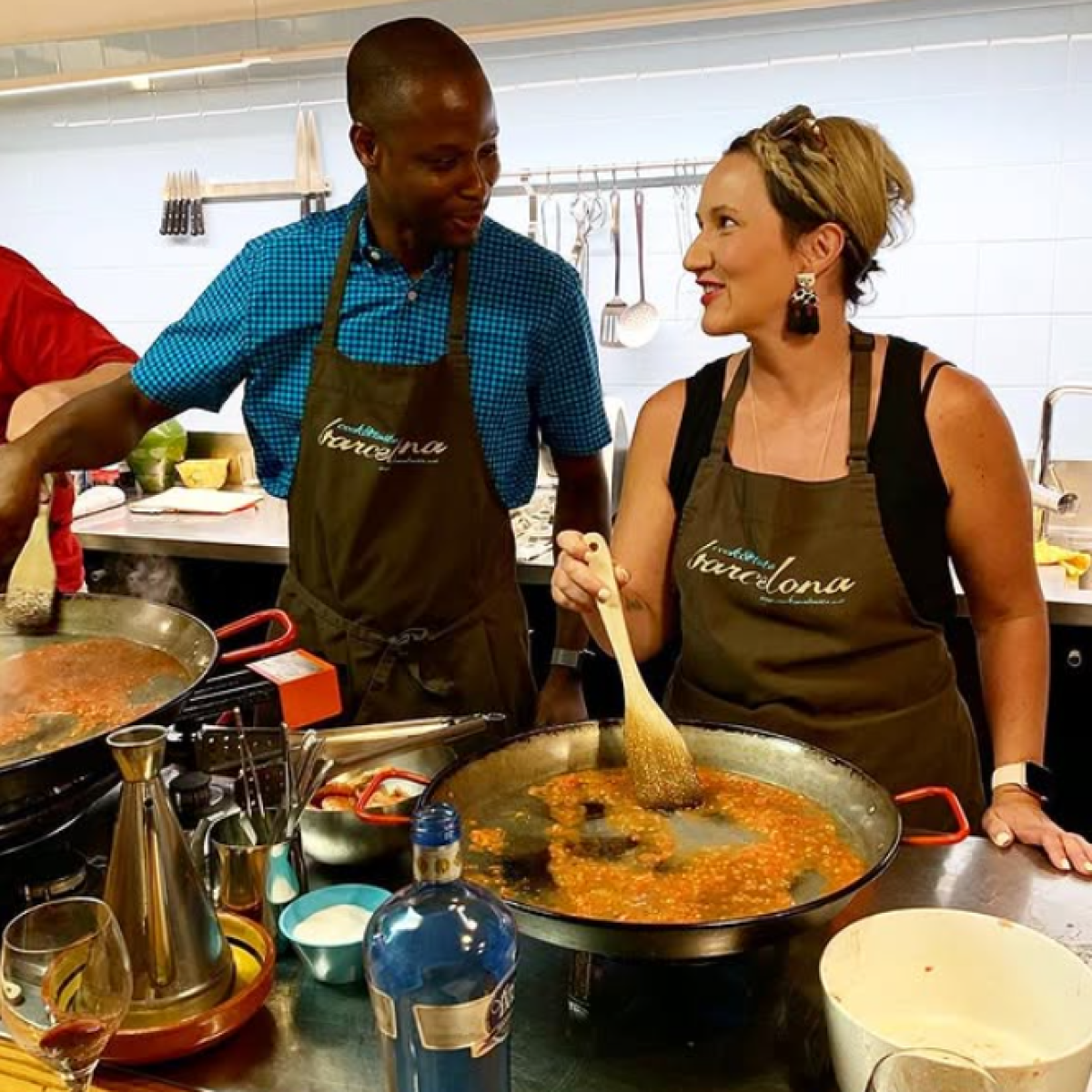 a group of people preparing food in a bowl