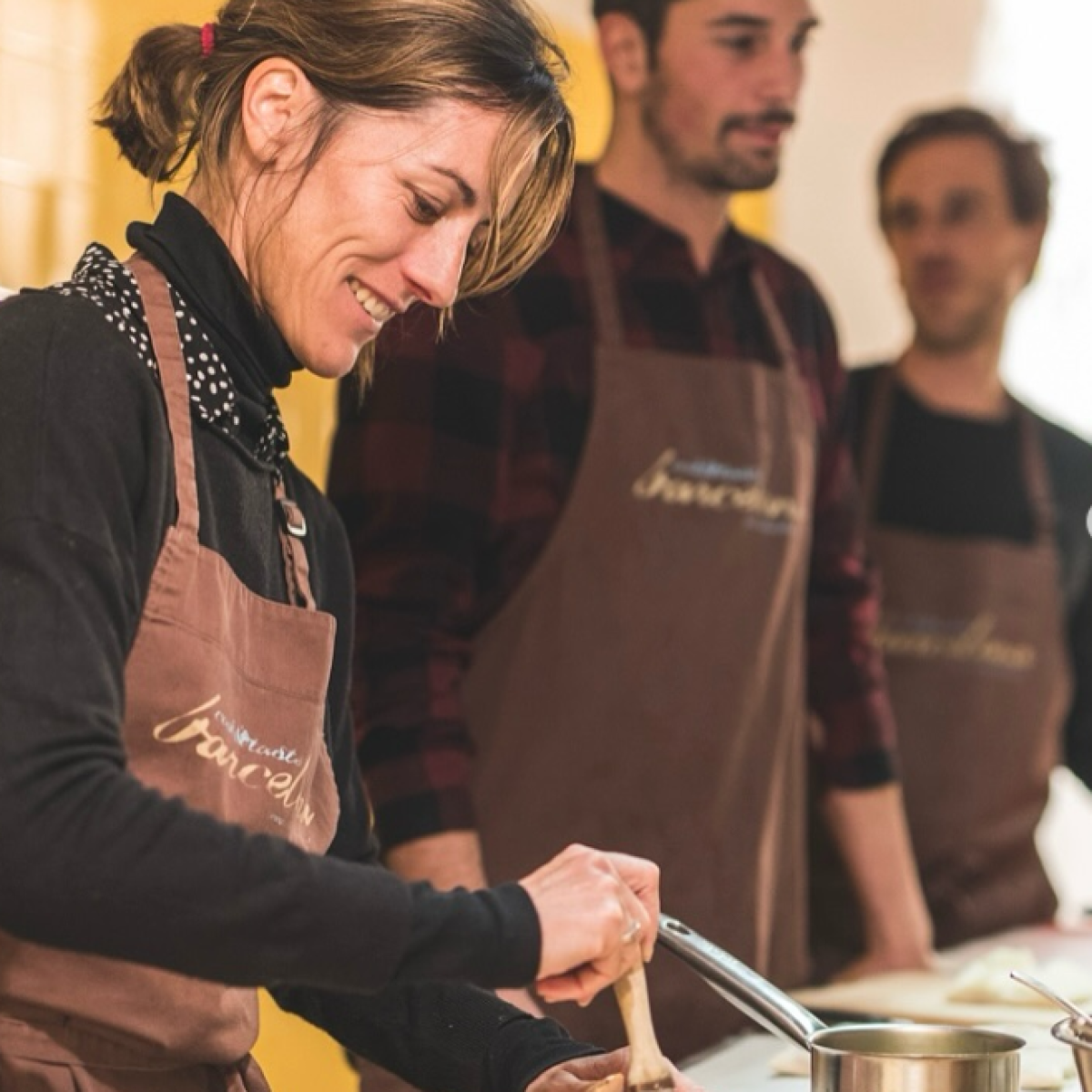 a group of people standing around a table