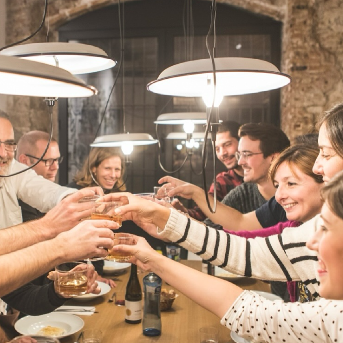 a group of people sitting at a table eating food
