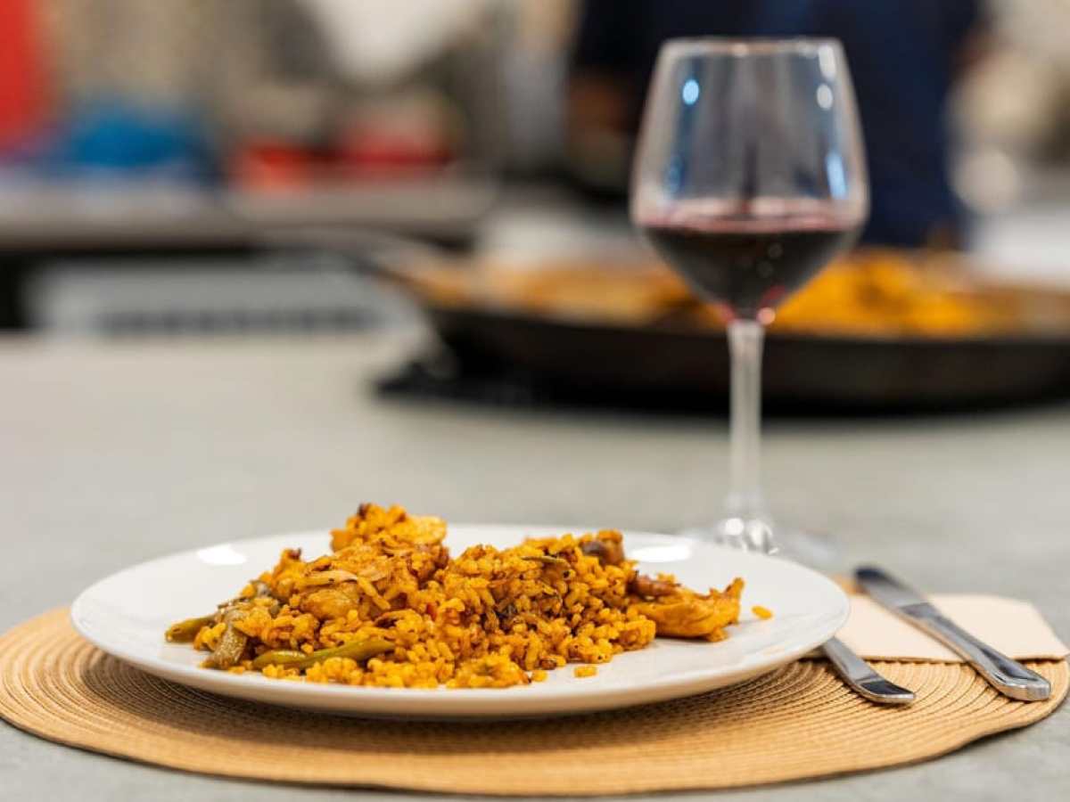 a plate of food and a glass of wine