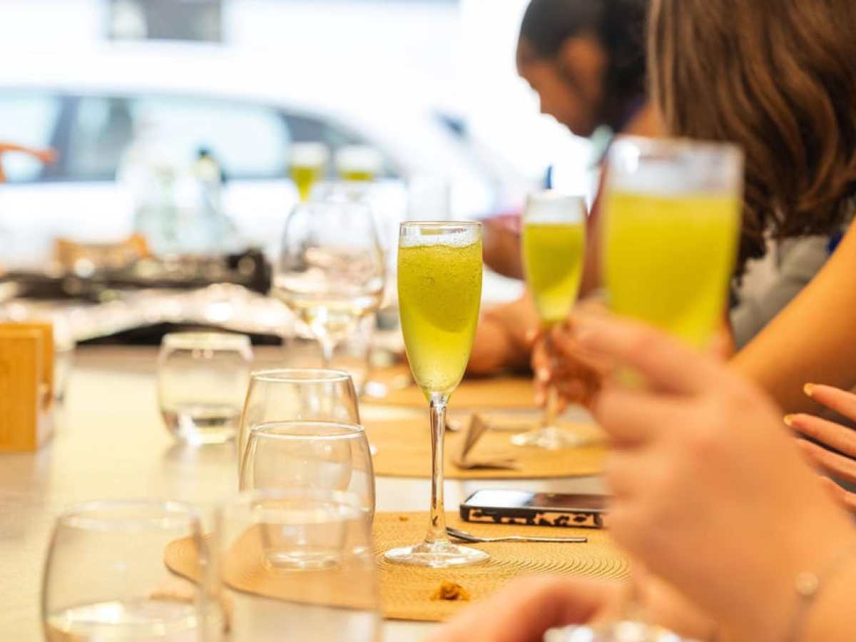 a group of people sitting at a table with wine glasses