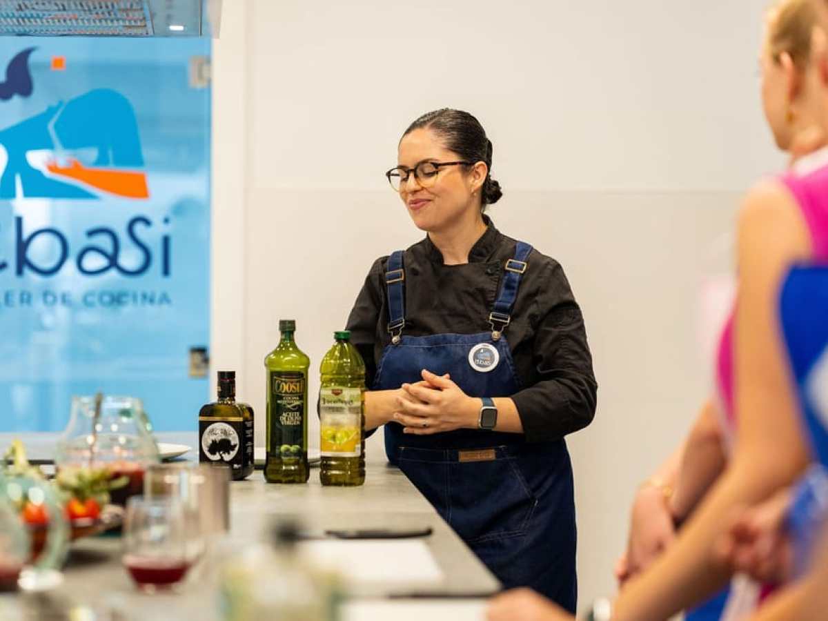 a person standing next to a bottle of wine