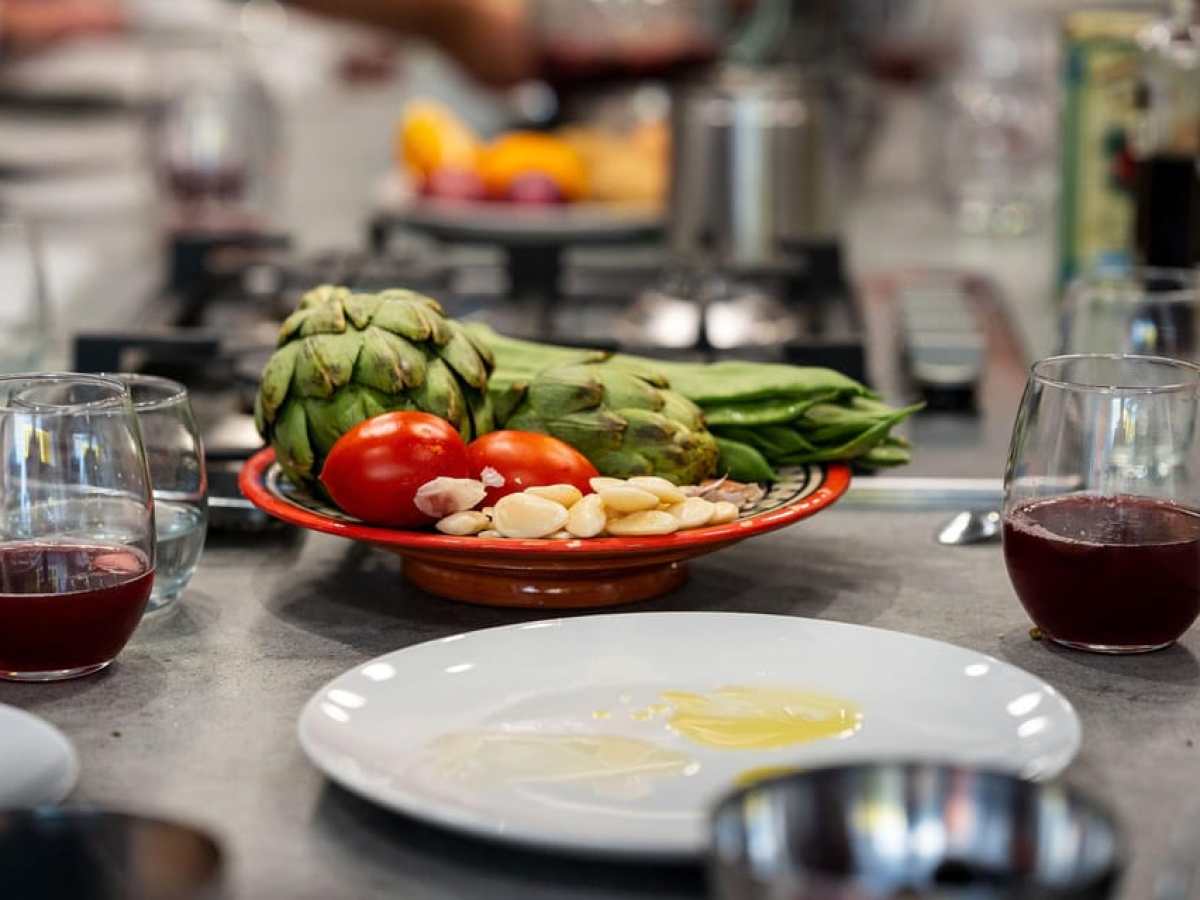 a plate of food and glasses of wine on a table