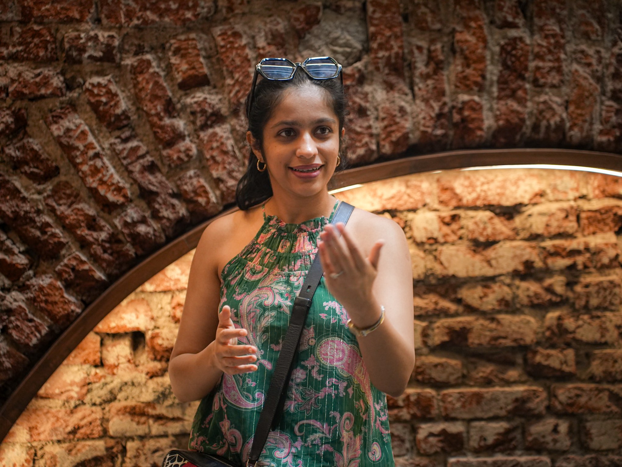 a person standing in front of a brick wall