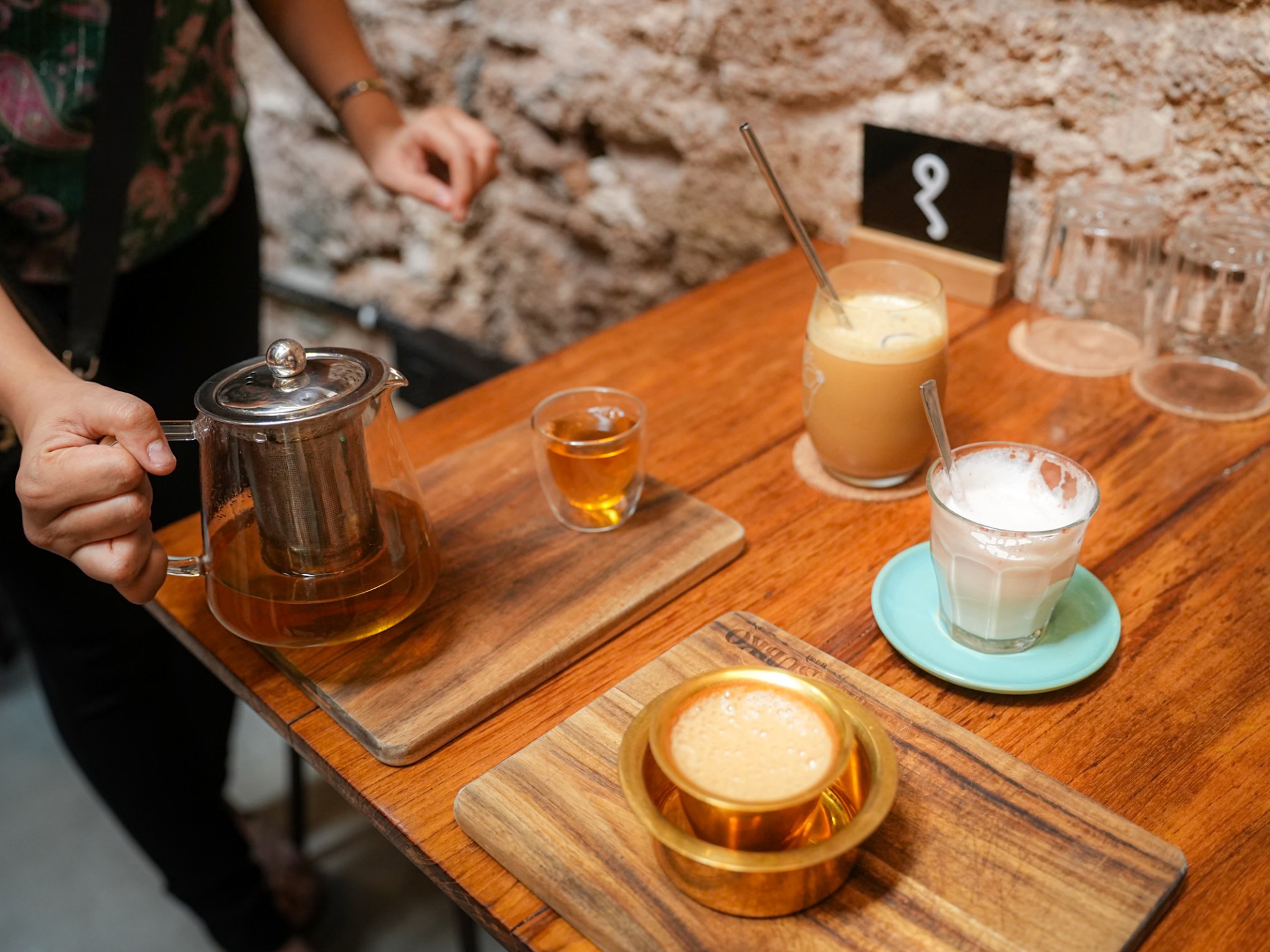 a person sitting at a table with a cup of coffee