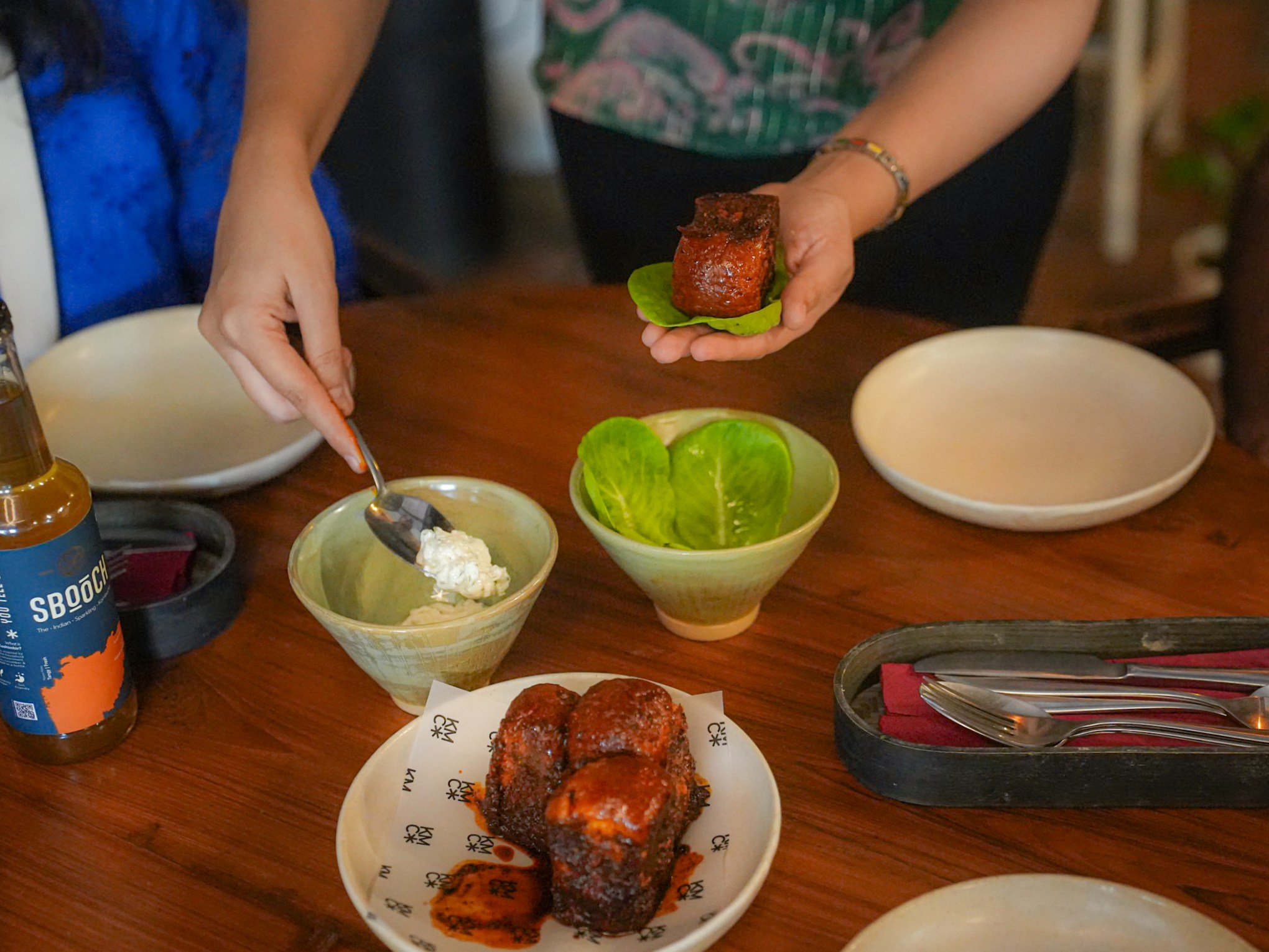 a woman sitting at a table with a plate of food