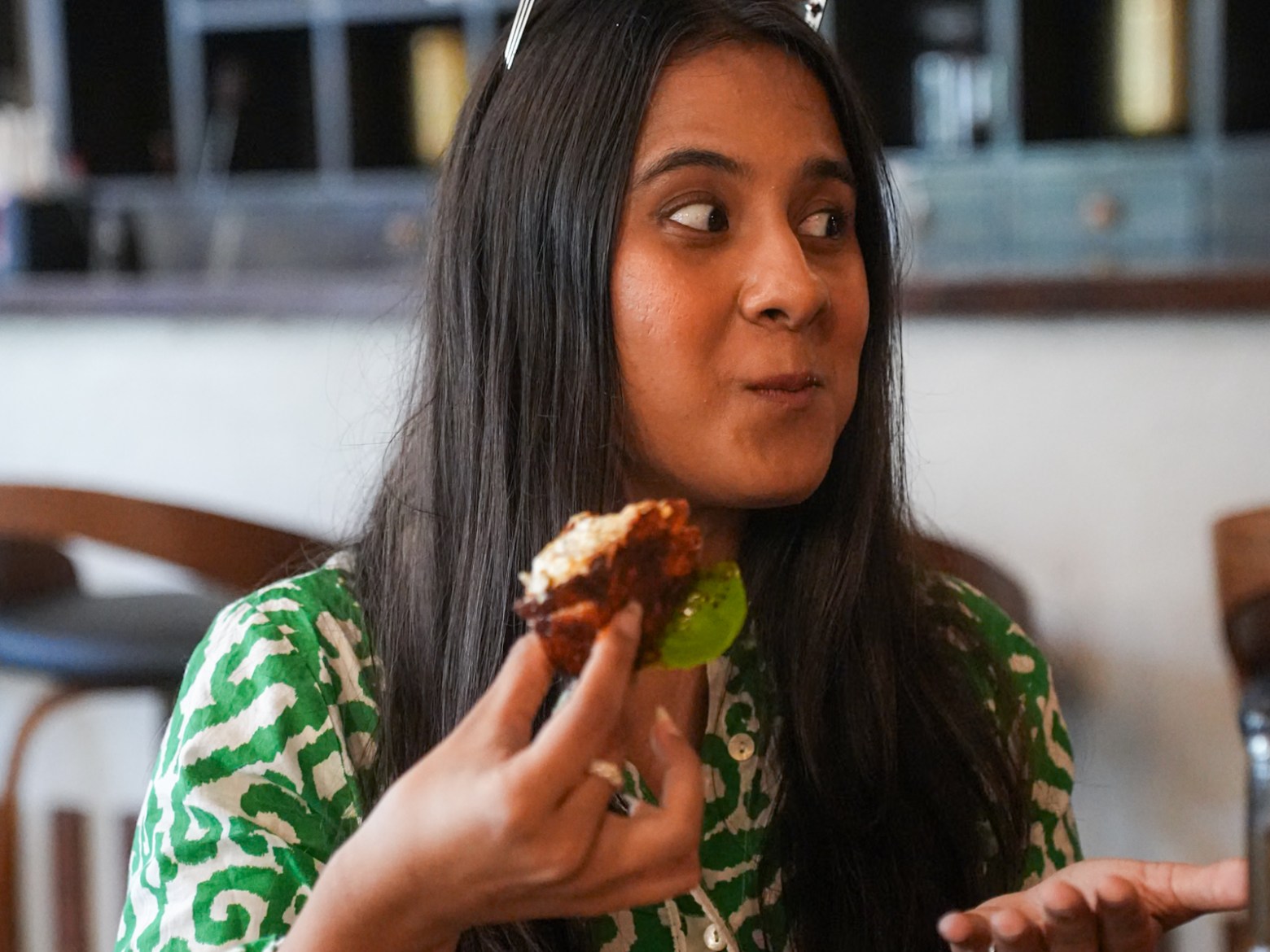 a woman sitting at a table eating food
