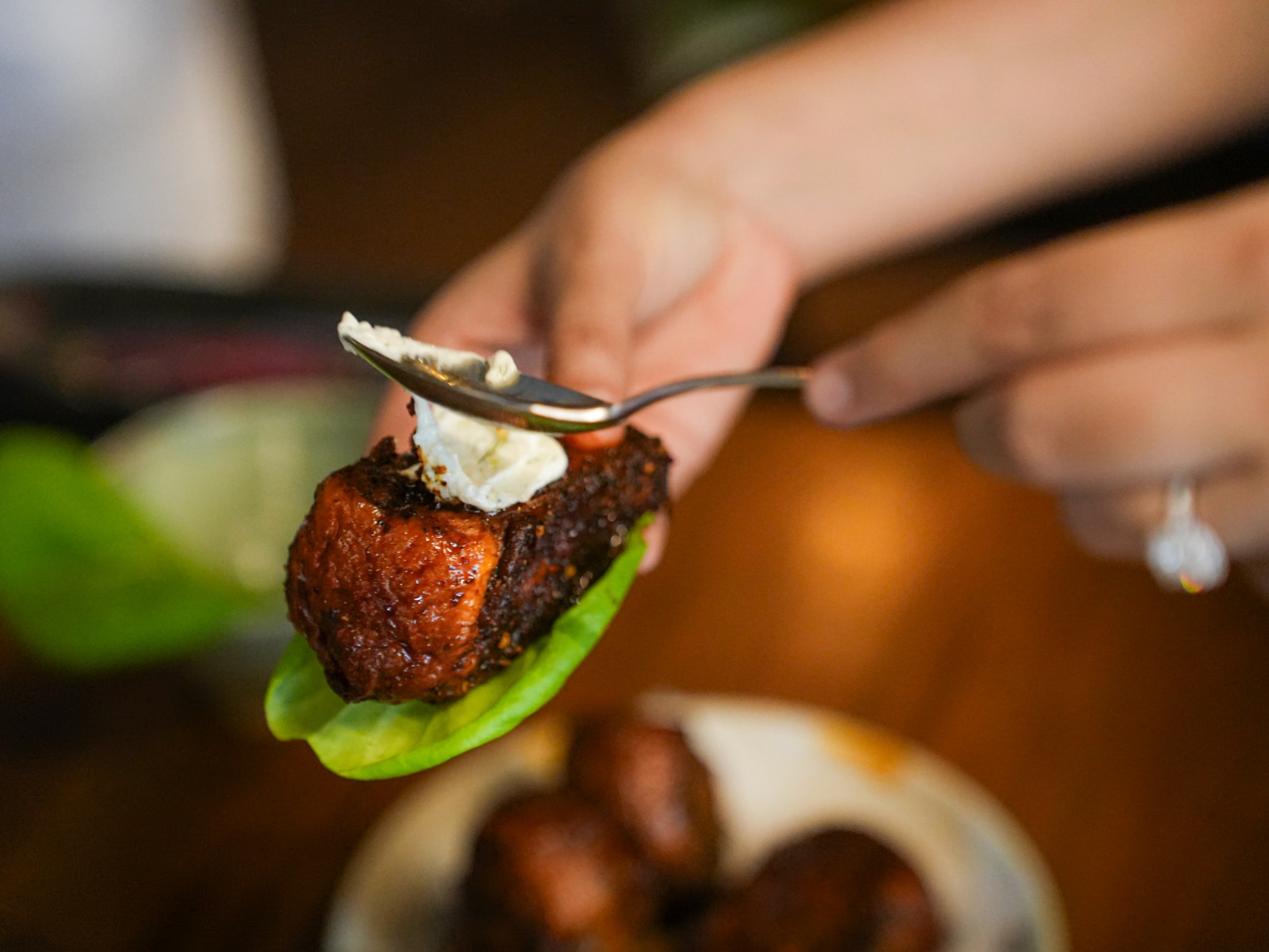 a close up of a person cutting a piece of food