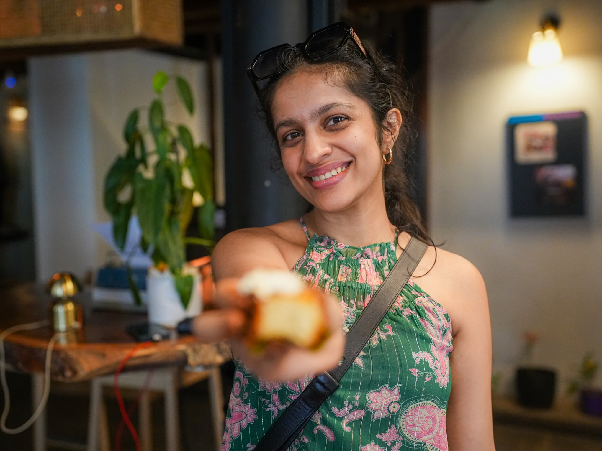 a young girl holding a piece of cake is smiling