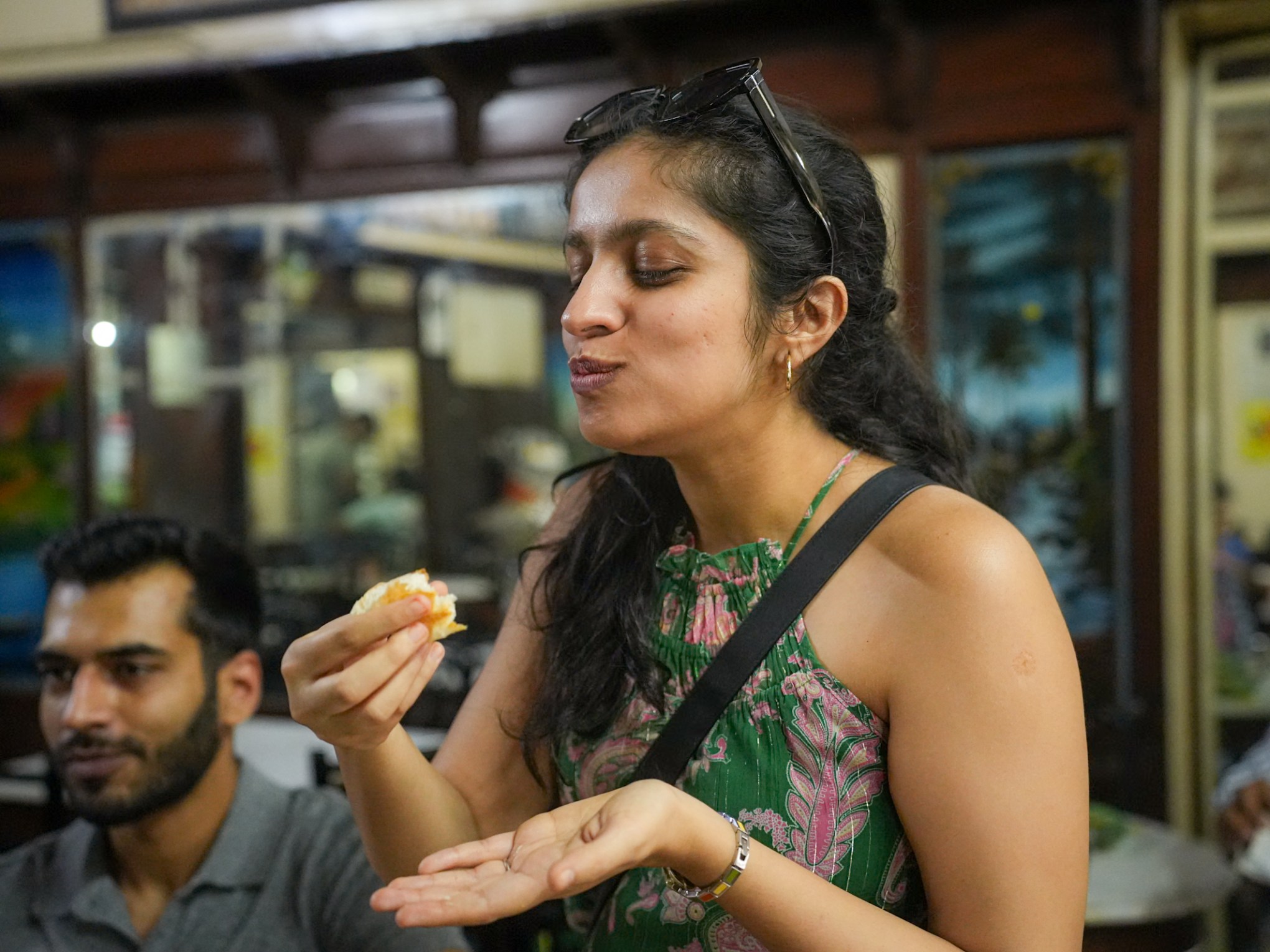 a man and a woman eating a slice of pizza